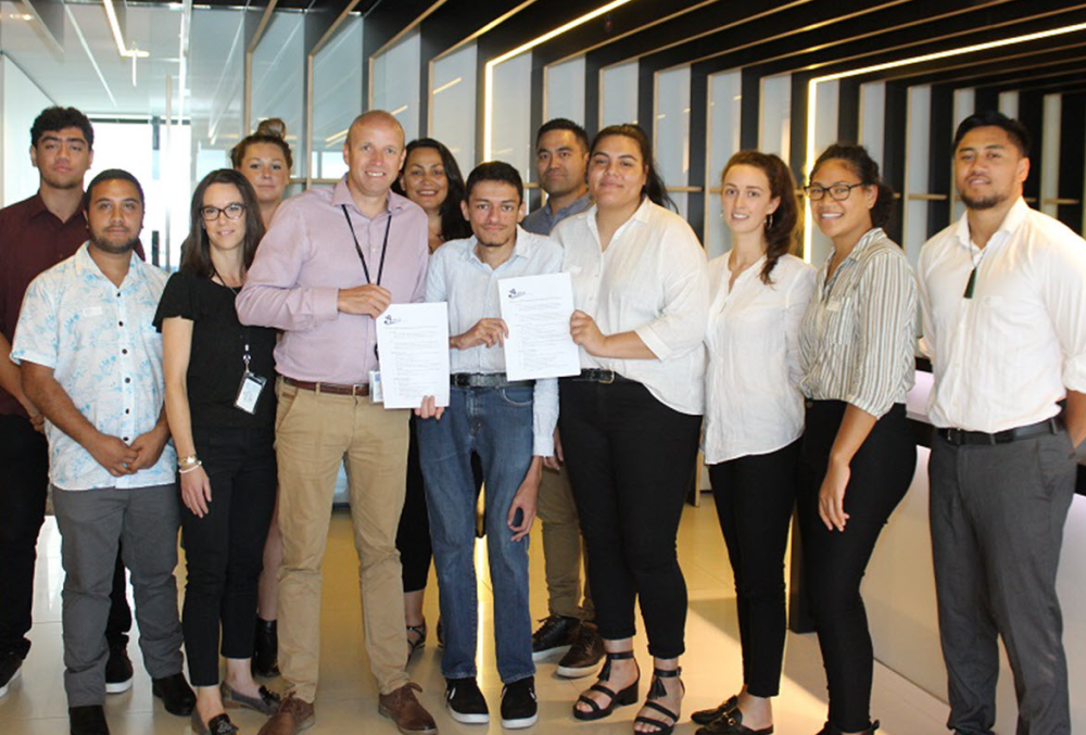 Beca Graduate- Executives standing.