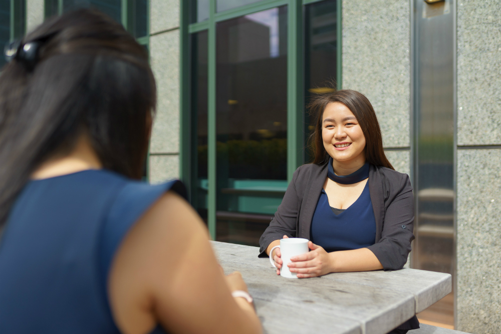 Valerie having coffee with a colleague