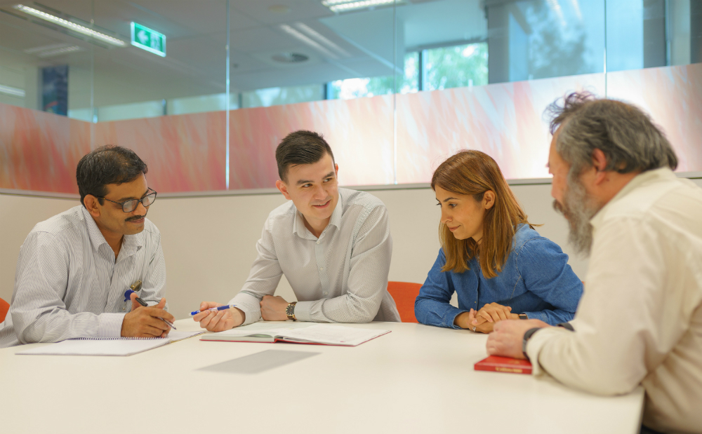 Tiernan talking with colleagues