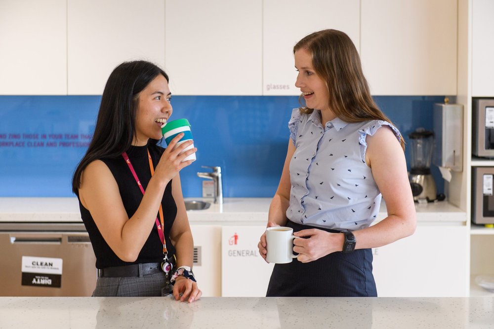 Two professional catching up over coffee