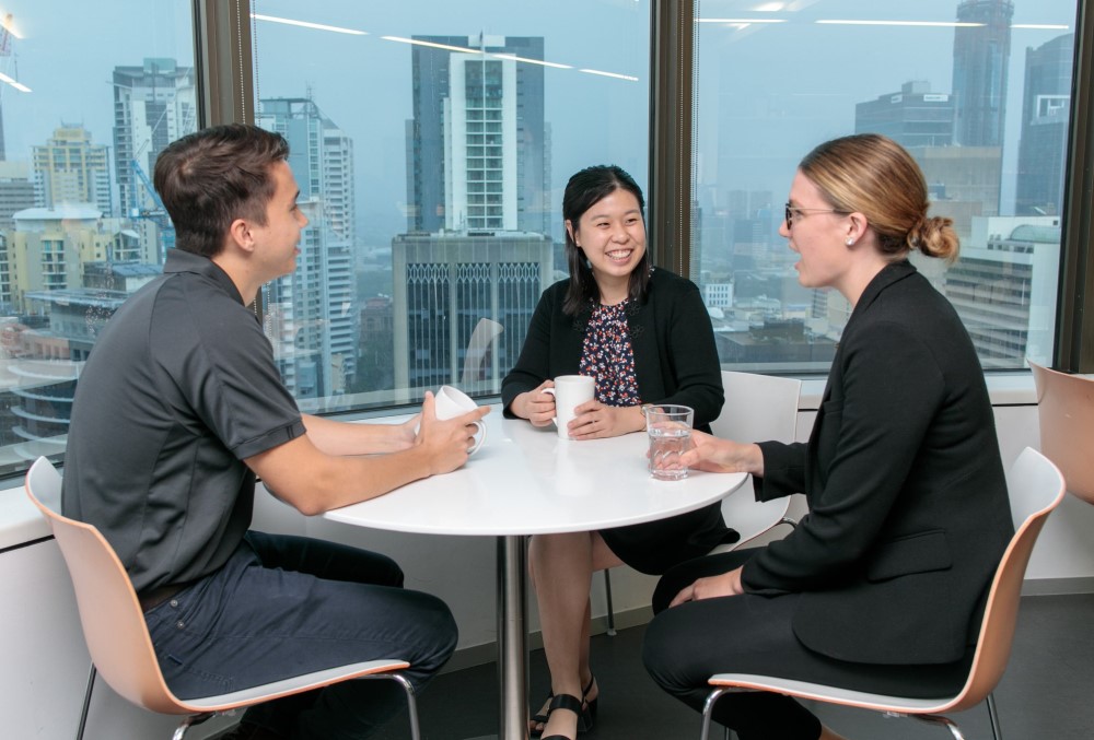 Worley Graduate - Young female professional having coffee with fellow graduates.