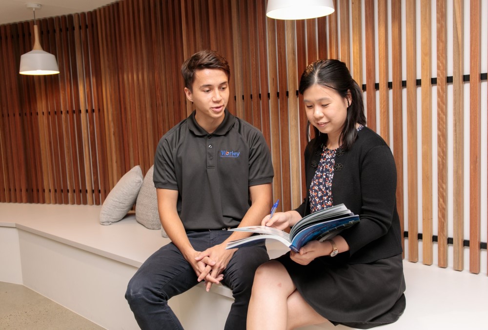 Worley Graduate - Young female professional sitting with her colleague.