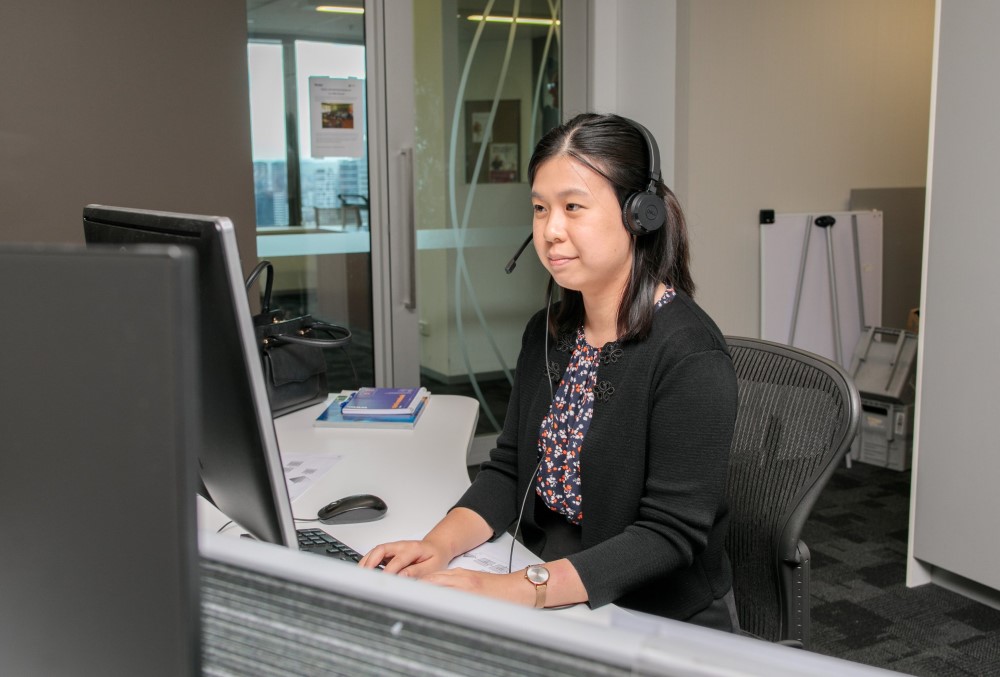 Worley Graduate - Young female professional sitting on her desk.