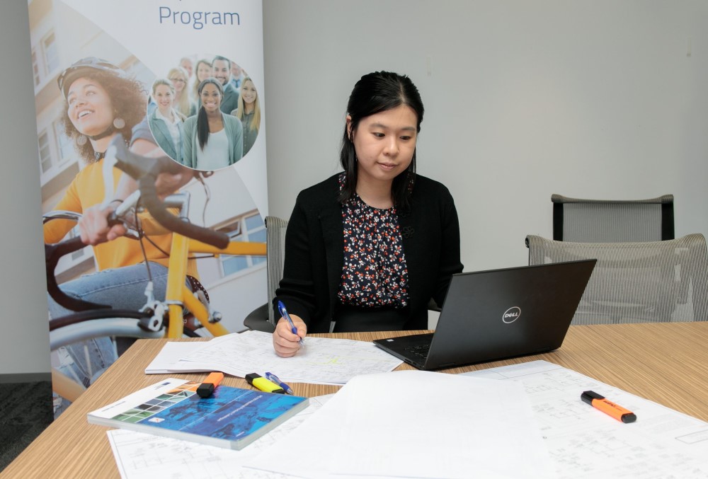 Worley Graduate - Young female professional typing on her laptop.