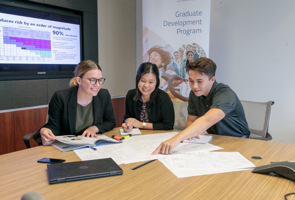 Worley Graduate - Young female professional working with her colleagues.