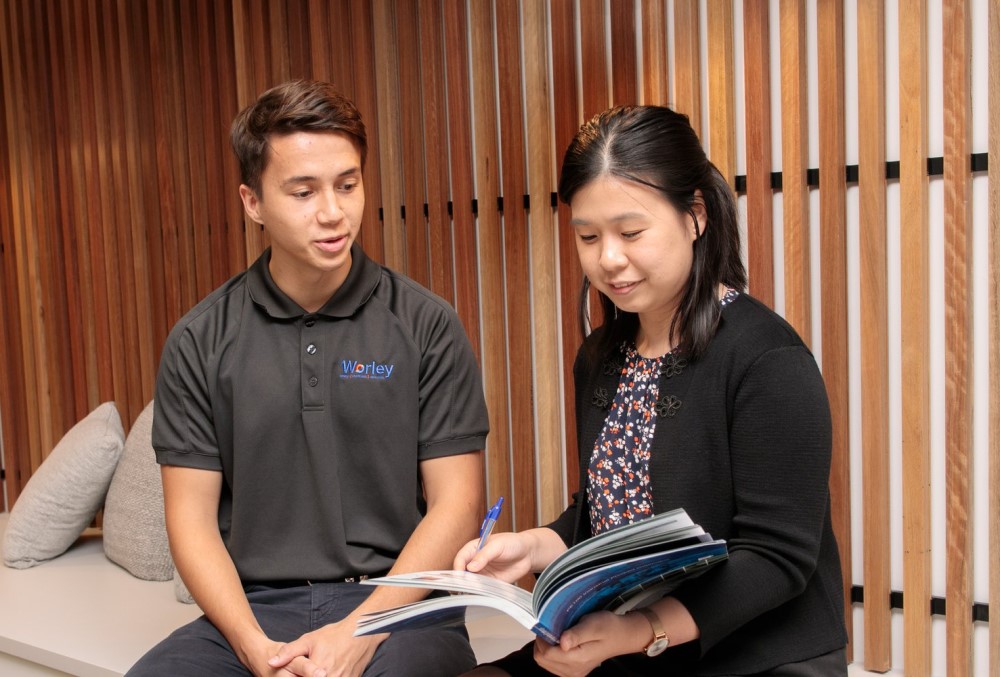 Worley Graduate - Young male professional working with a fellow engineer.