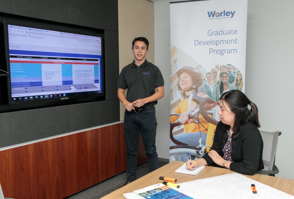 Worley Graduate - Young male professional conducting a meeting.