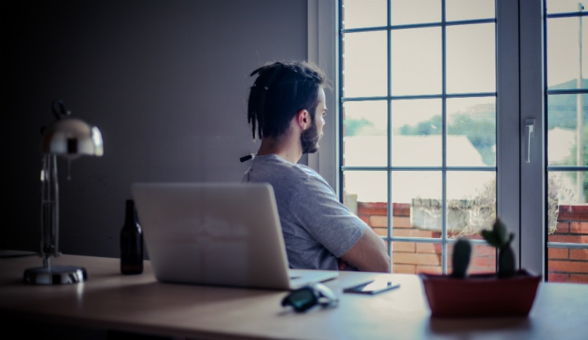 Graduate student looking at the window thinking of career plans