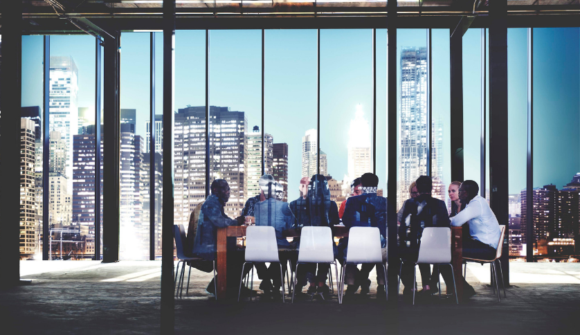 A group of investment bankers in a meeting room