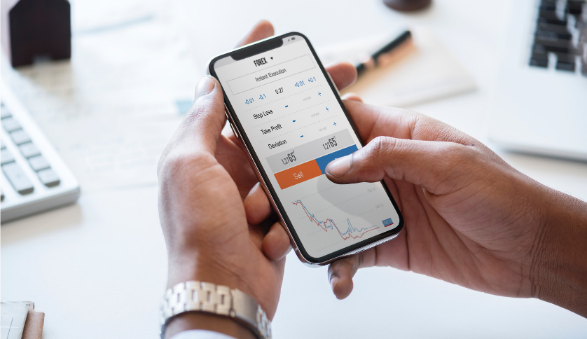 A trader holding a mobile phone