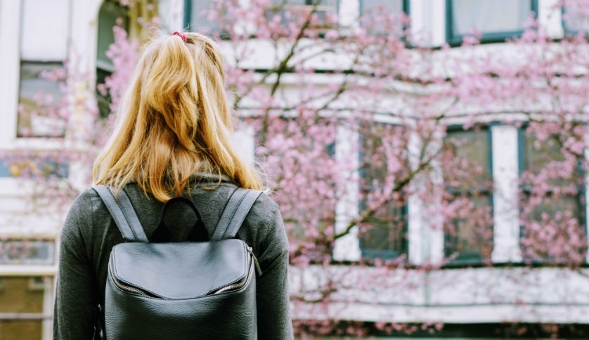 A student looks at a building.